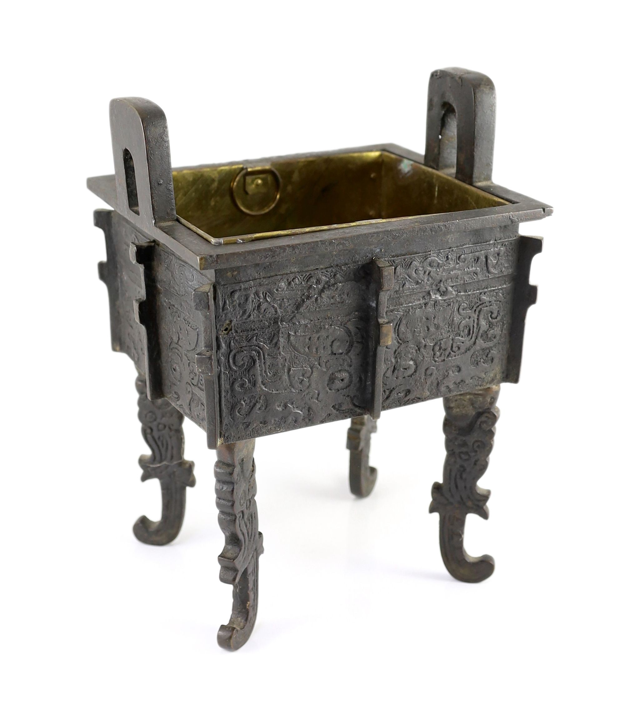 A Chinese archaistic bronze rectangular censer, fangding, 17th/18th century 34cm high, 24cm wide, 20cm depth later liner and repairs to legs